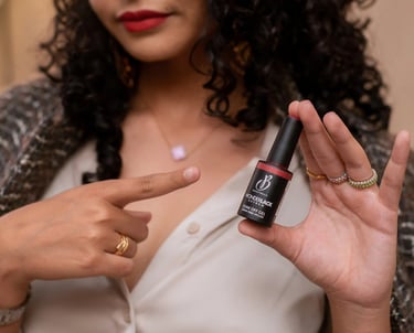 a woman holding a bottle of nail polish