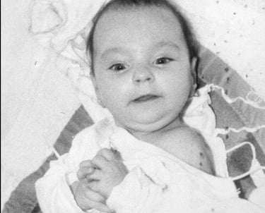 a baby looking up towards the camera