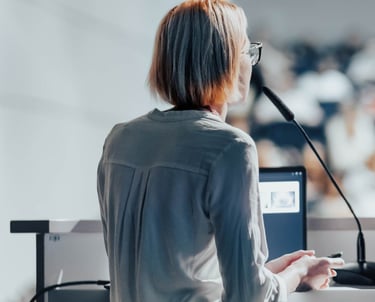 Conference microphone rental for live events in Dubai – speaker at podium using gooseneck mic