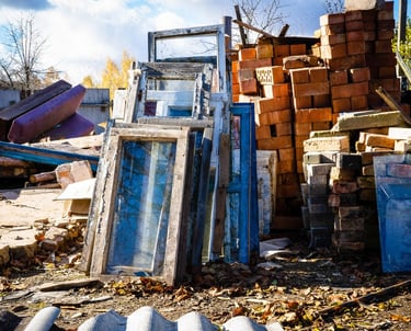 construction debris stacked on empty lot