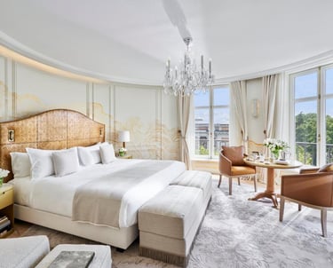 Luxury Suite Bedroom – Spacious suite with a king-size bed, crystal chandelier, and panoramic views.