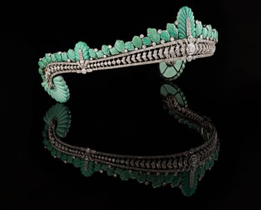 Angled view of Nancy Astor’s Cartier turquoise and diamond tiara with reflection on black surface.