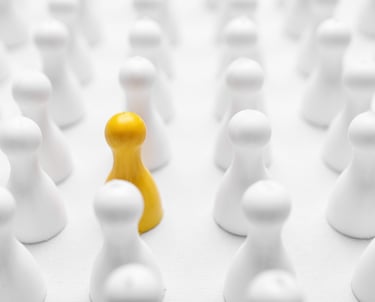 Closeup of yellow pawn among others on white background