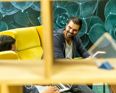 Two Men Sitting On Sofa