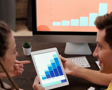 Man and Woman Looking at Bar Graphs On Screens