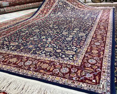 a man is holding a large rug in a room