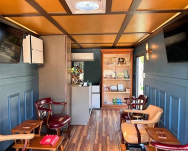 Inside view of our mobile cigar lounge showcasing our humidor, smoke eater and big-screen TVs.