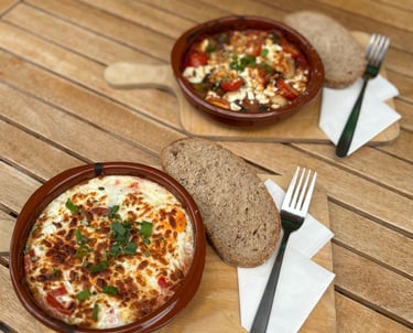 a bowl of food on a table with bread