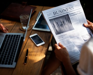 Someone reading the newspaper headlines in corporate environment