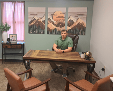 Daniel Ferguson sitting in his office at a desk.