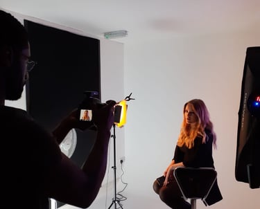 a woman sitting in a chair in a studio