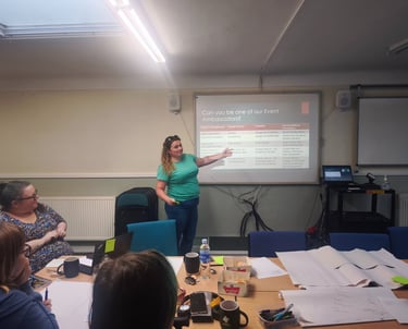 a woman in a green shirt is standing in front of a presentation