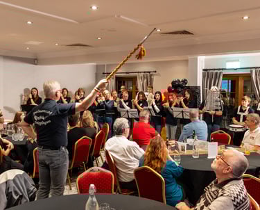 Indoor celebration with seated guests and live wind instrument performance
