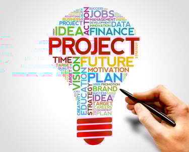 Illustration of a light bulb filled with colourful business words like PROJECT, STRATEGY, and VISION