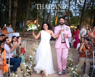 A happy bride and groom celebrate during a destination wedding ceremony in a tropical forest in Thailand.