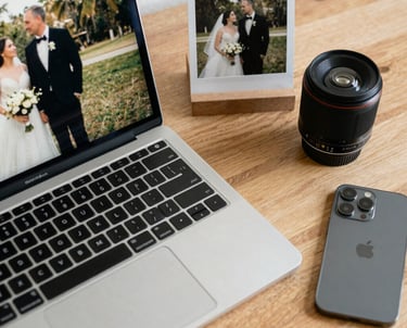 Photographer editing photos on a MacBook Pro with a digital tablet in a modern studio setting.