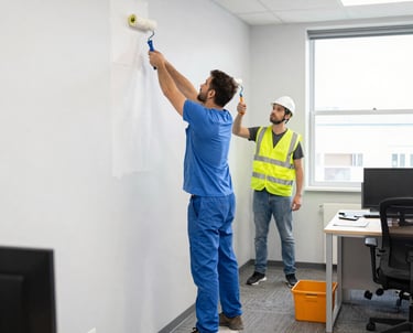 a man with a paint roller painting a wall