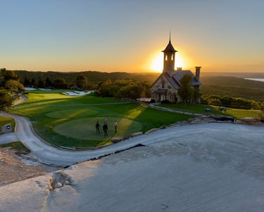 Sunset at Top of the Rock golf course with chapel and scenic Ozark Mountain views.