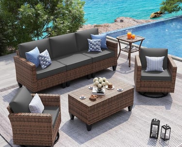 Modern 5-piece brown wicker patio furniture set with grey cushions on a pool deck overlooking the ocean.