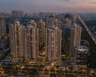 Aerial sunset view of Heartbeat City Noida Sector 107 luxury residential high-rise apartments and city skyline.