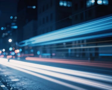 Abstract photography of motion-blurred lights in a city at night, deep blue and ice blue streaks, energetic and professional, North American / US.