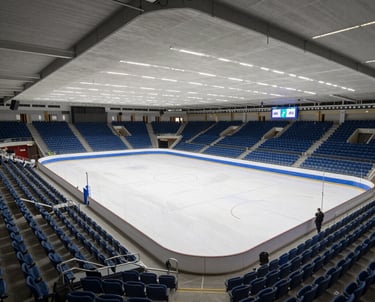 a man riding a skateboard down a street next to tall buildings