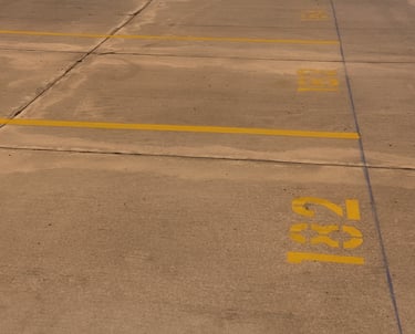 yellow lines with stenciled numbers in parking lot