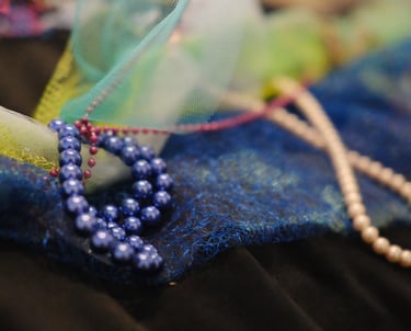 various sizes of pearls on net like fabric and mesh meant to be played with as tactile elements 