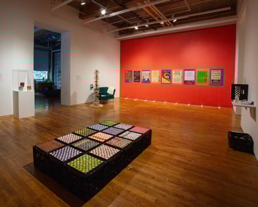 Exhibition wide angle view of different sensory objects including milk crates and touchable posters.