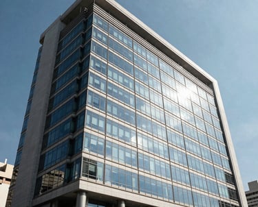 Wide-angle photography of a contemporary office building exterior in the Vila Nova district of Santos, Brazil, reflecting the blue sky, symbolizing stability and modernity.