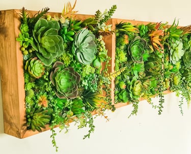 Vertical wall garden featuring artificial succulents in rustic wooden shadow box frames.