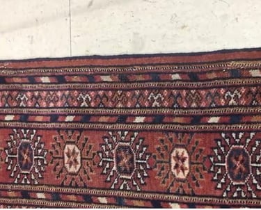 Professional rug restoration repairing worn edges, tears, and holes with precision care.