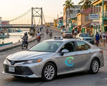 A silver Toyota Camry ride-sharing taxi parked near the iconic Swing Bridge in Belize City.