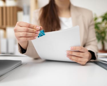 a woman is holding a piece of paper with a blue pin pin pin