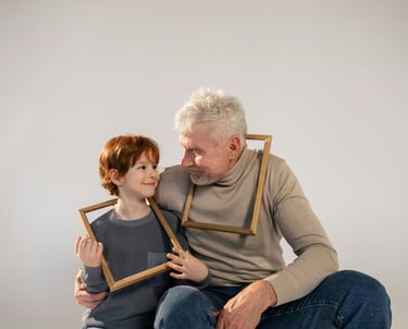 a man and a child are holding frames in front of a white wall