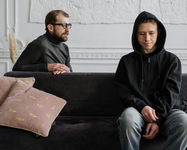 a man and woman sitting on a couch