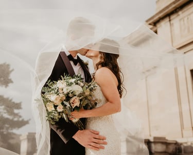 a bride and groom standing in front of a building