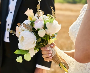 a bride and groom are holding a bouquet