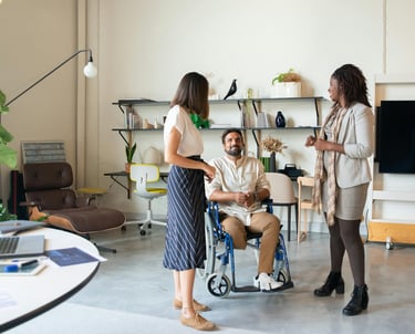 a man and woman in wheelchairs in a room
