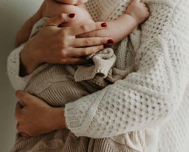 a woman holding a baby in her arms