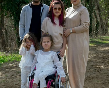 a family posing for a picture in a park