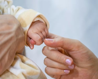 a baby's hand holding a baby's finger