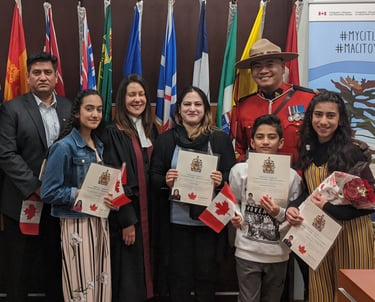 a happy family TWC Financial client standing in front of a Canadian flag