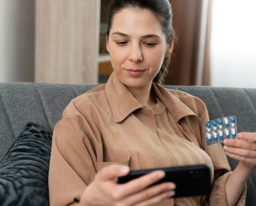 a woman sitting on a couch holding a remote control