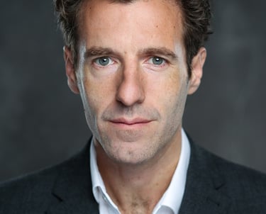 James Rose, a well workplace specialist, posing for a photo in a suit