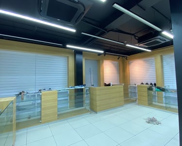 a room with a desk and a glass wall