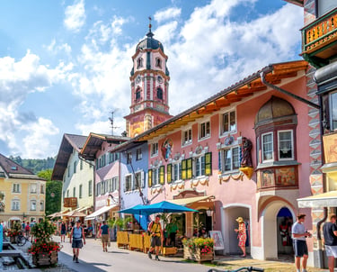 Colorful alpine houses and St. Peter and Paul church tower in Mittenwald, Bavaria, Germany.