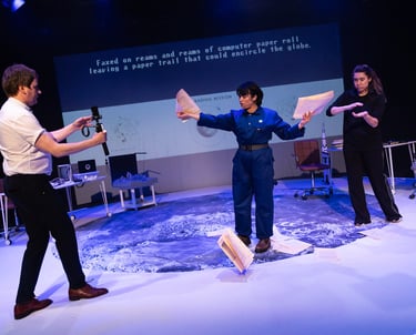 Three people on the surface of the moon, casting papers out across it