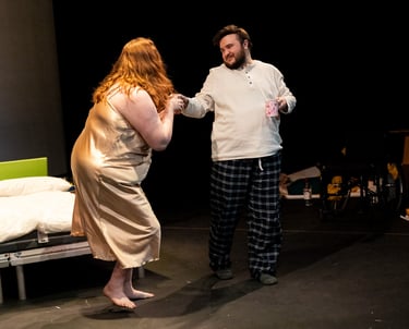 A white man and woman dancing tenderly in nightwear