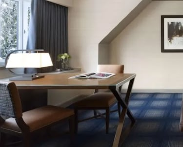 a hotel room with a bed and a desk